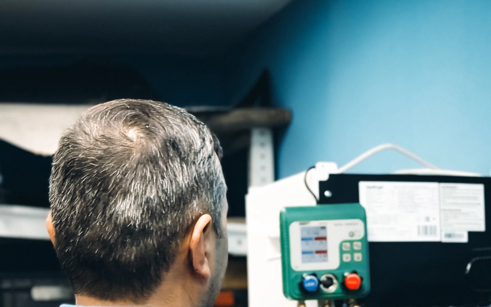 Technician carrying out air-conditioning maintenance